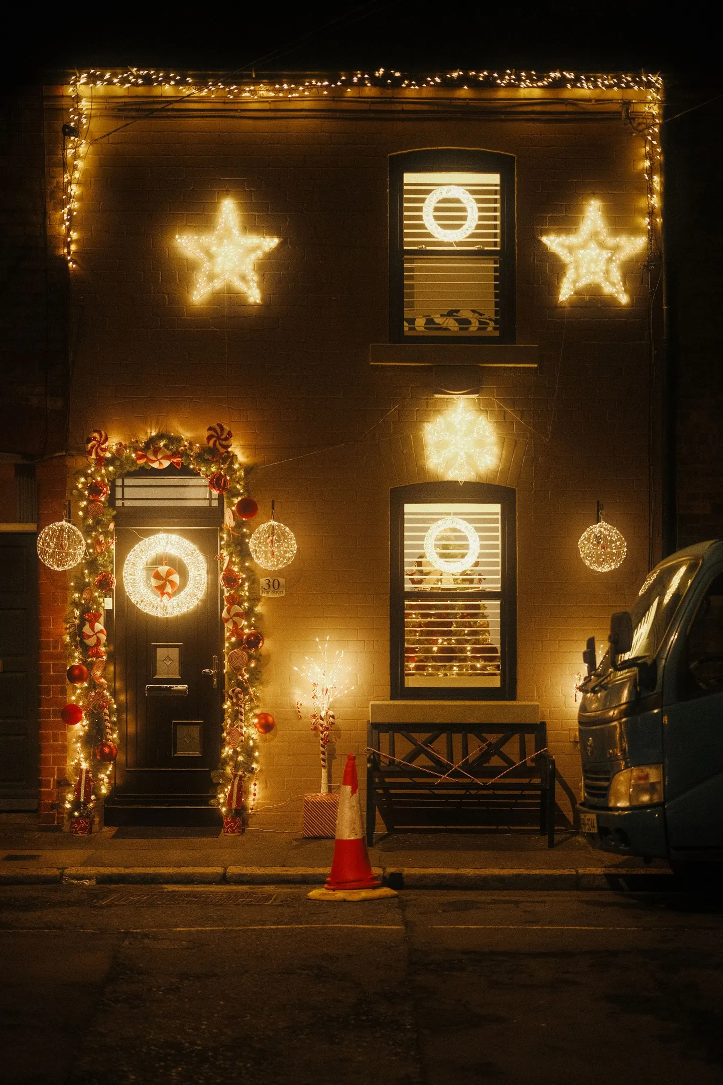 Illustrative stock photograph of warm holiday lights on a house exterior