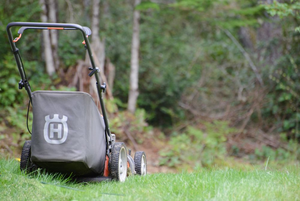 Stock photograph of a lawn mower on grass