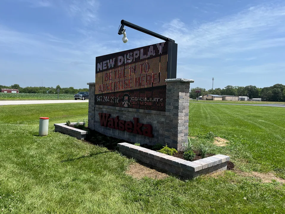 Low block borders and planted beds surrounding a commercial sign