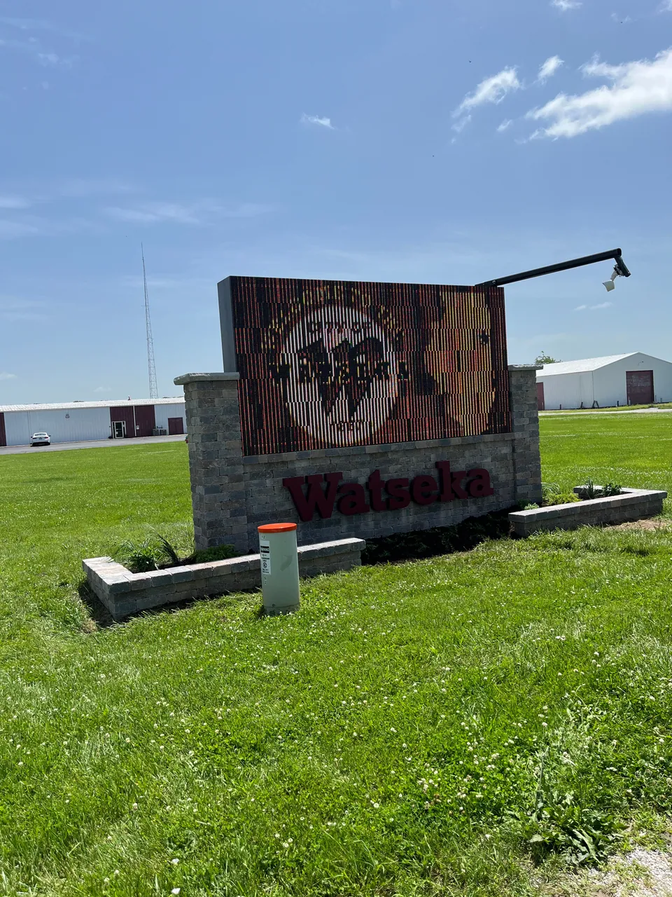 Front view of the planting beds and block borders around a sign